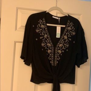 Cute tie front top with embroidery.